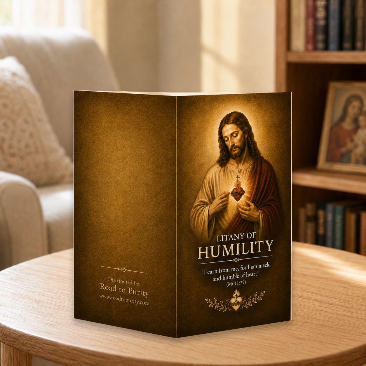 Litany of Humility prayer card displayed in a warm Catholic reading area