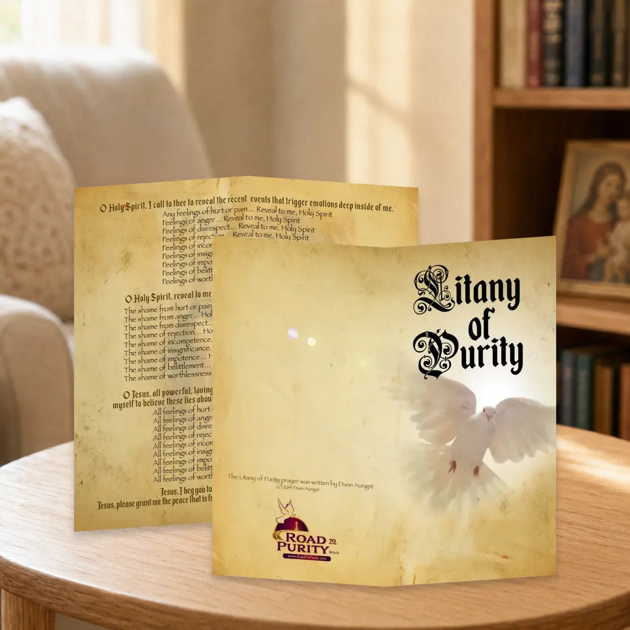 Litany of Purity prayer card displayed in a warm Catholic reading area