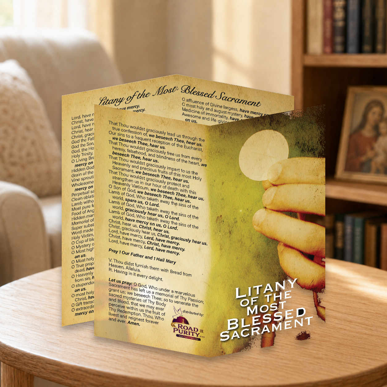 Litany of the Most Blessed Sacrament prayer card displayed in a warm Catholic reading area
