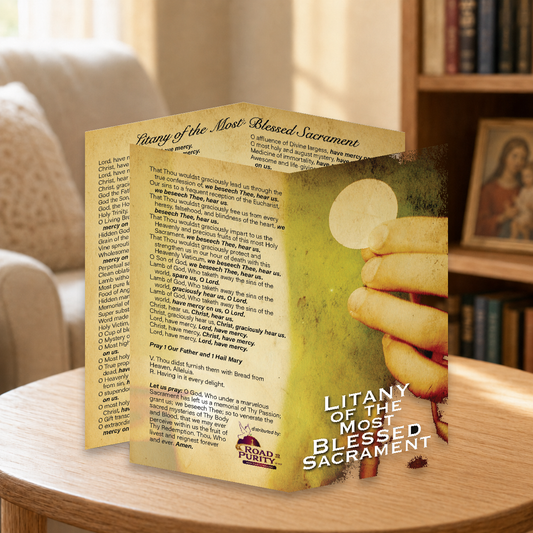 Litany of the Most Blessed Sacrament prayer card displayed in a warm Catholic reading area