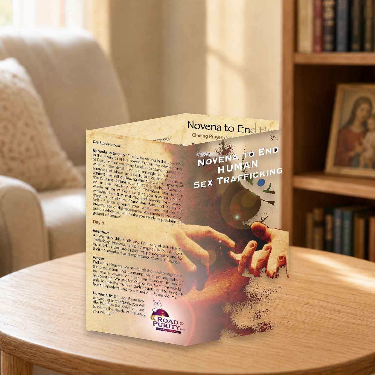 Novena to End Human Sex Trafficking prayer card displayed in a warm Catholic reading area